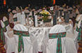 White chair coverings with Tartan patterned sash decor and round tables