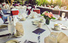 Anniversary party with white and red chair covers and sashes