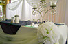 Event table setting with candle holder and glass table top