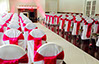 Event decor with rented white chair covers and red sashes