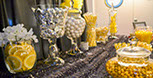Table decorated with yellow items for anniversary party.