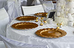 Wedding decorator table set with copper plates.